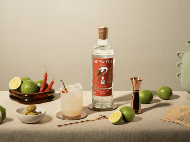 Sipsmith Chilli & Lime Gin surrounded by chillis and lims in bowls and also cut open, showing the green flesh