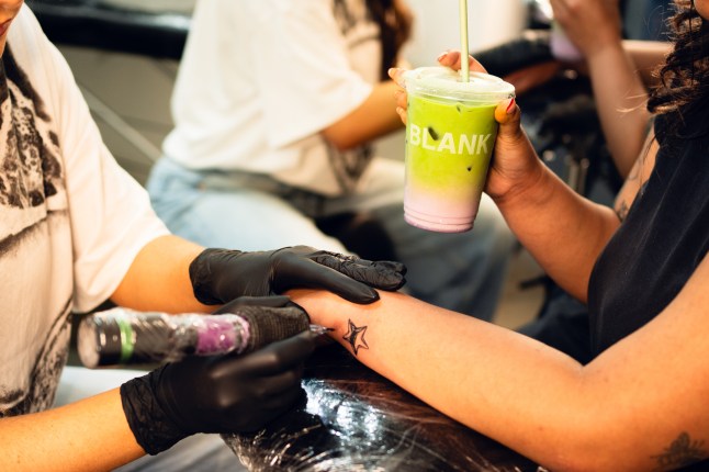 Model gets tattoo whilst drinking from Blank Street cup