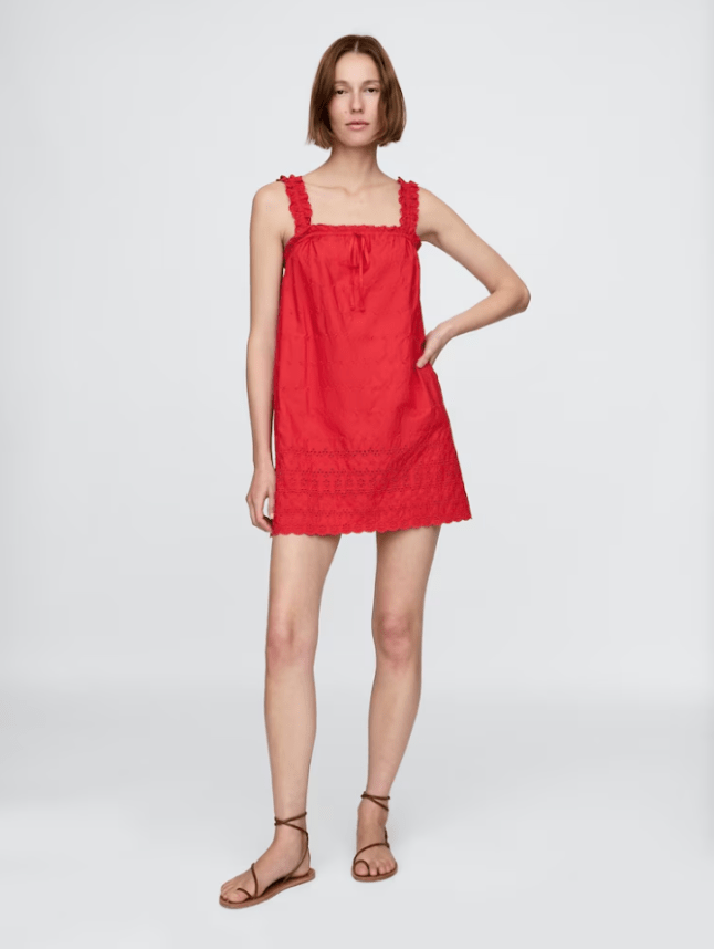 Model wears red DÔEN Eyelet Shift Mini Dress from GAP