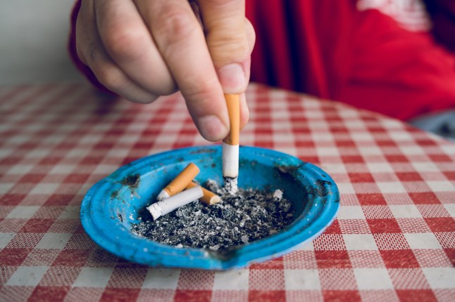 Close up on man Man extinguishes the cigarette in the ash tray quitting no smoking lung health problems