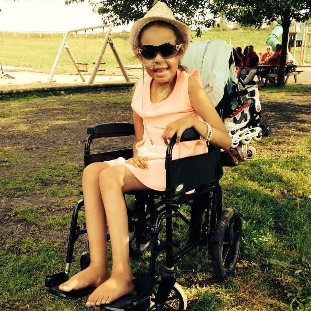 Young Milly Hadden in a wheelchair