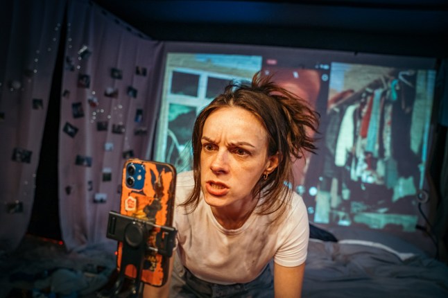 Eleanor Hill speaking to her phone in the play Overshare.