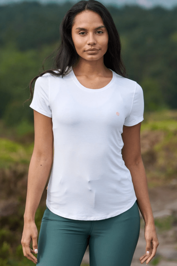 Female wears white tshirt with green sports leggings