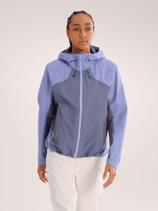 Female wearing light purple zip up jacket and cream trousers