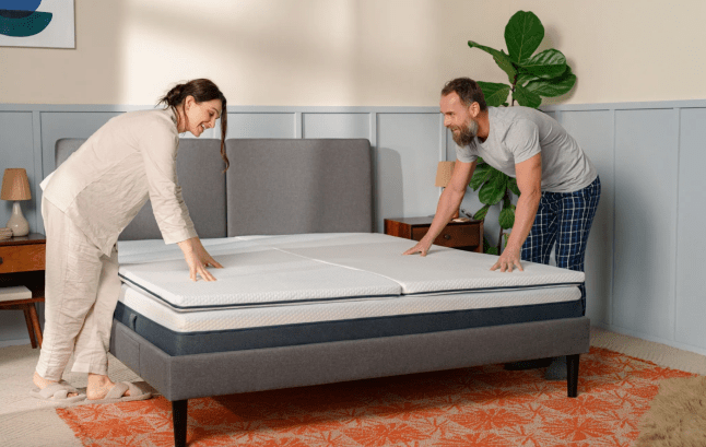 Emma Flip Mattress Topper with two people, male and female, pressing down on it