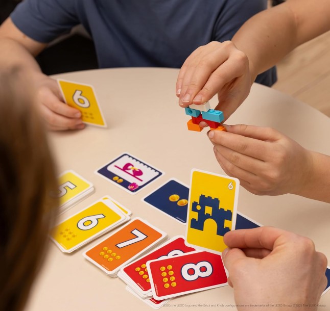 Hands playing a card game from LEGO
