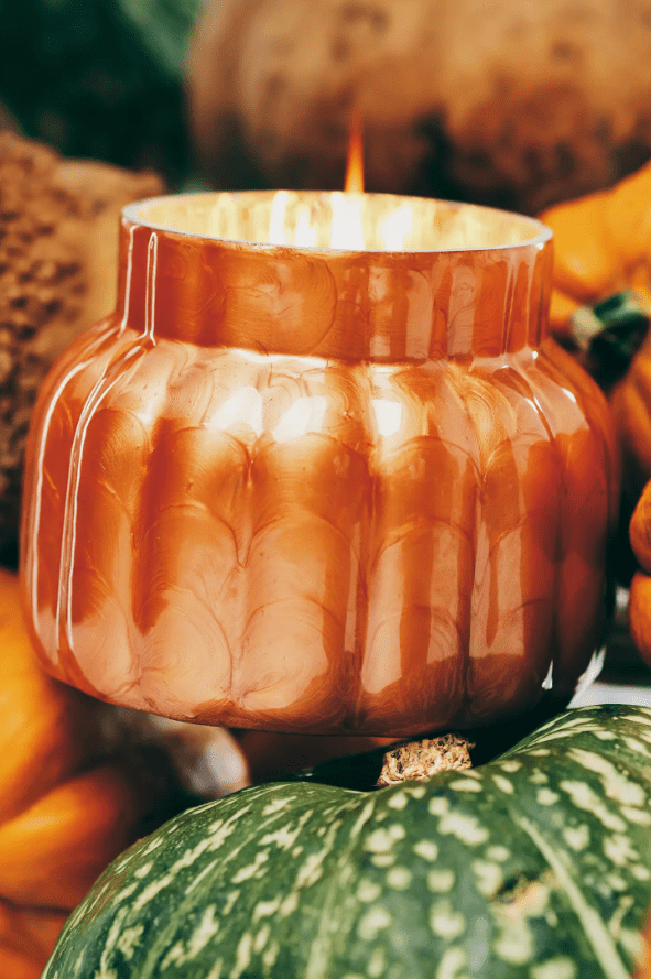 Orange Anthropologie candle that looks like a pumpkin