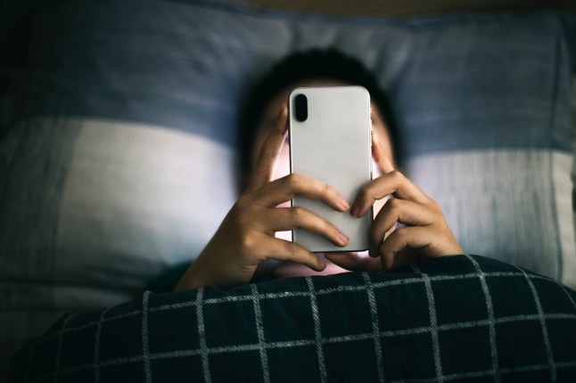 Man in bed on smartphone