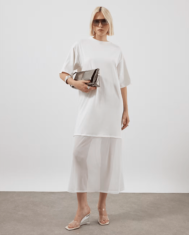 Female wears white River Island t-shirt dress with white mesh skirt