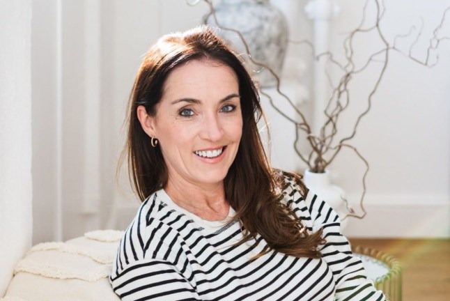 Claire Vowell smiles to camera while seated