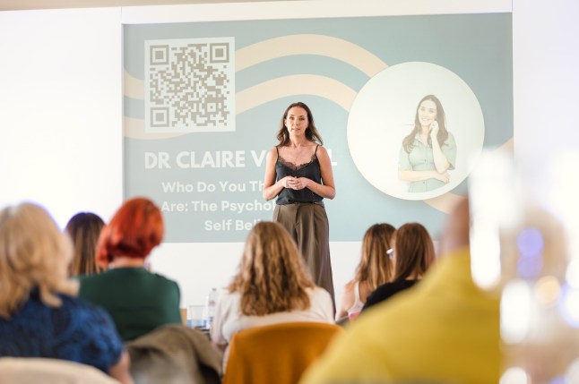Claire Vowell speaks in front of a room of people