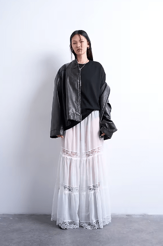 Female wears black TOPSHOP jacket, tshirt and white skirt with lace