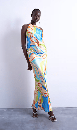 Female wears printed halterneck TOPSHOP dress