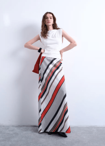 Female wears white TOPSHOP top with colourful stripe skirt