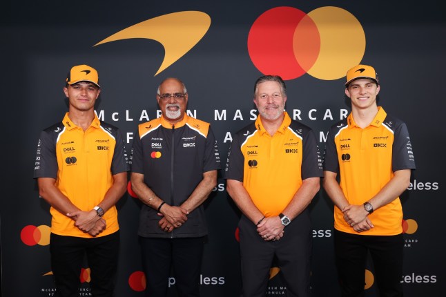 McLaren team pose with new branding under Mastercard McLaren
