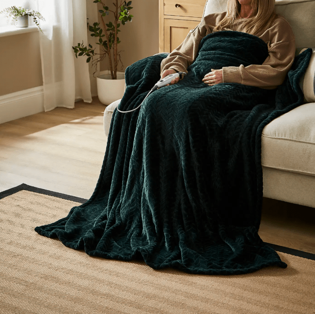 Female under Dunelm Amelia Cable Electric Throw