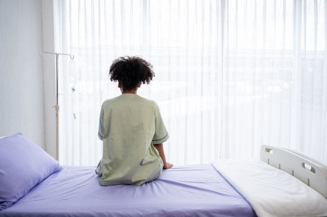 Lonely patient sitting on the hospital bed