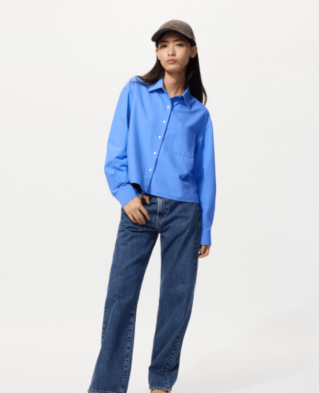 Female wearing blue Uniqlo x JW Anderson Oxford Boxy Shirt