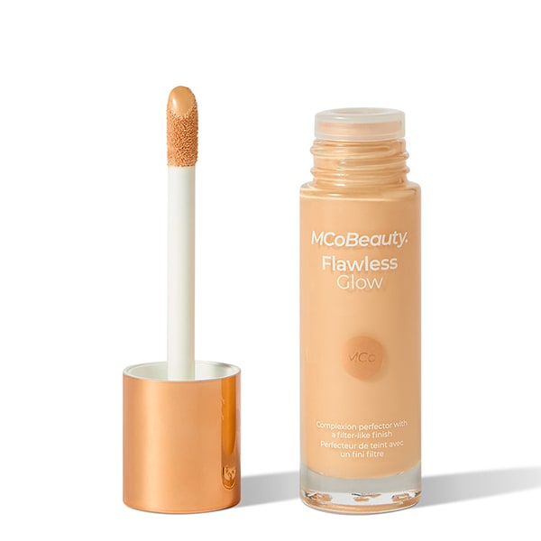 Glass bottle opened, with applicator next to it