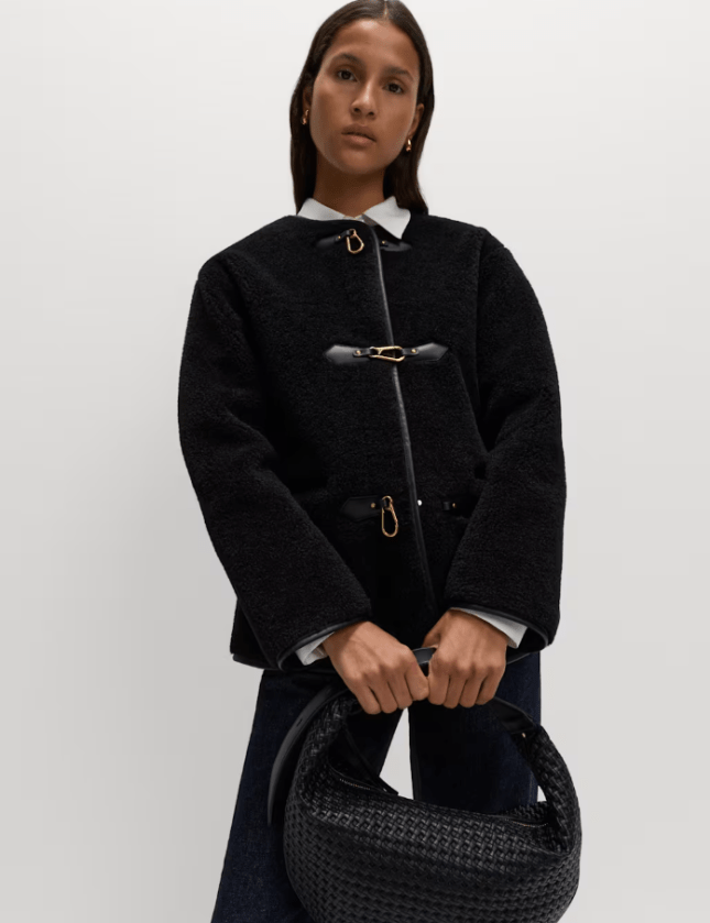 Female wears Faux Fur Buckle Trim Coat from M&S