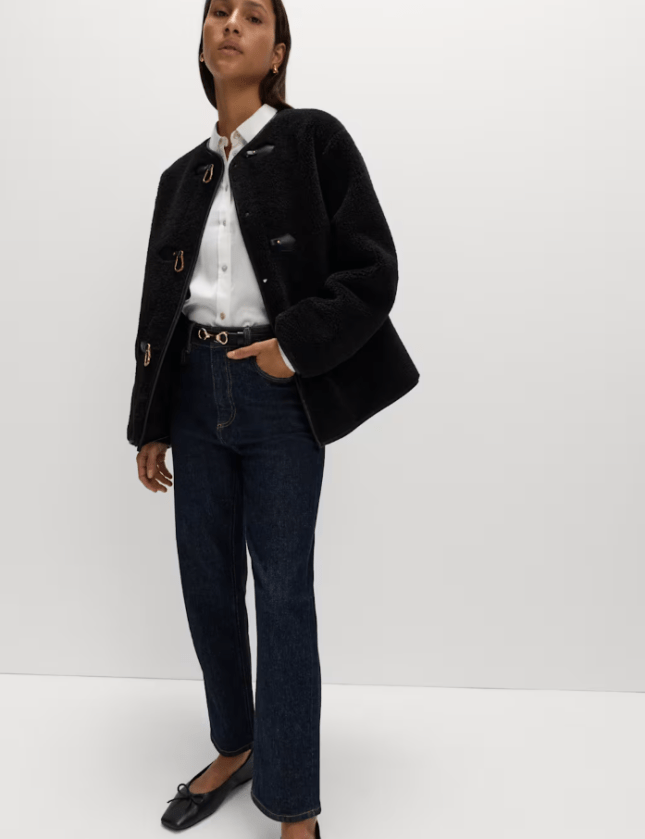 Female wears Faux Fur Buckle Trim Coat from M&S