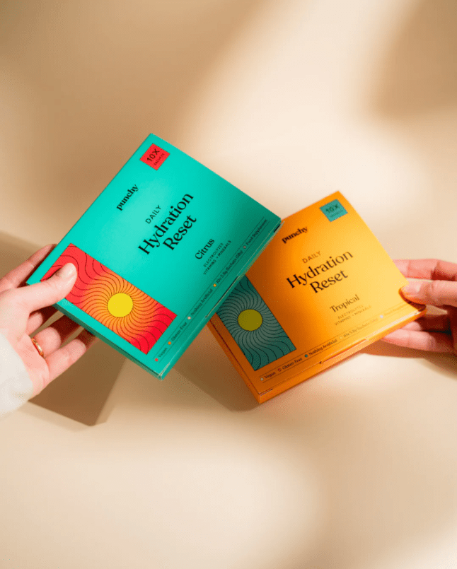 Hands holding Punchy Drinks hydration sachets