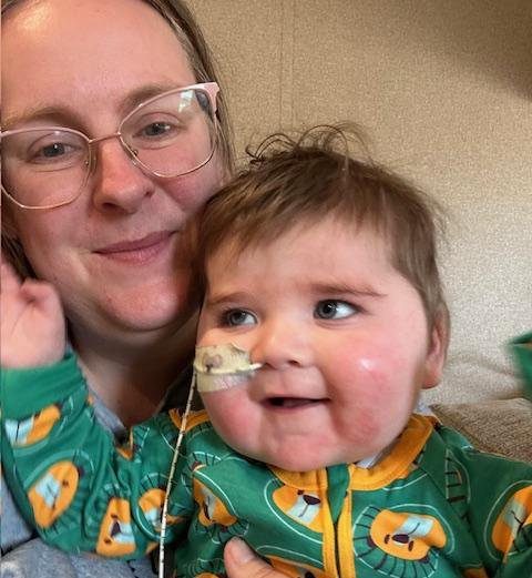 A selfie of a mother with her one-year-old baby who has a tube in his nose