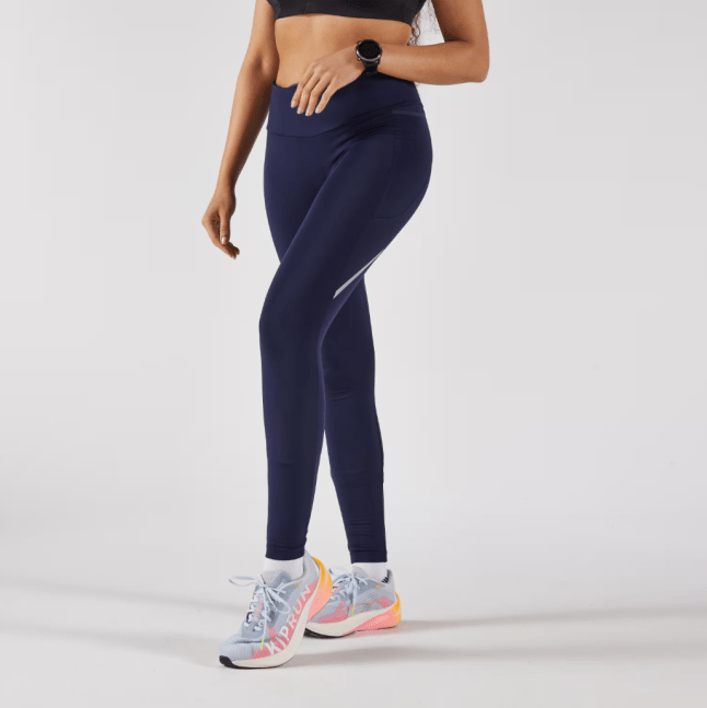 Female wears navy KIPRUN Run 500 Women's Warm Running Leggings