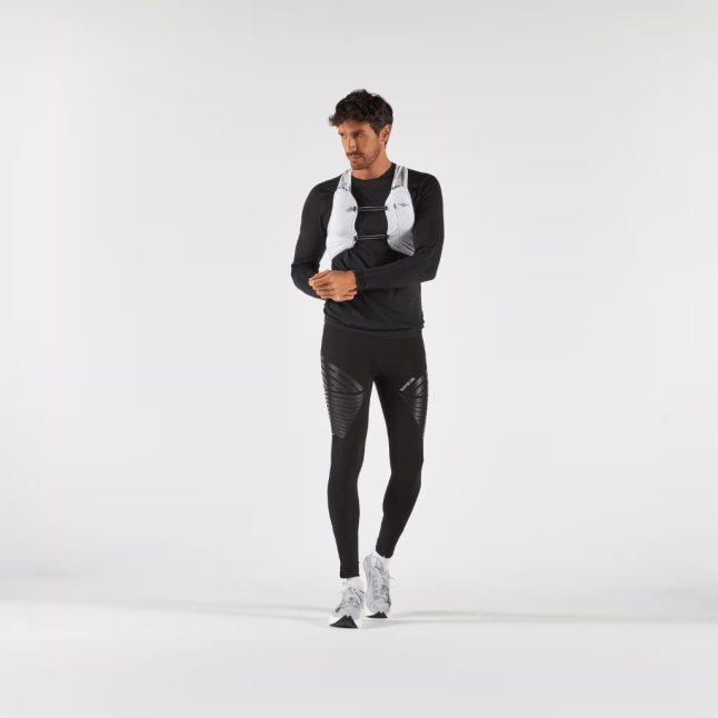 Male wears KIPRUN Run Compress 900 RHEON Men's Muscle Support Tights