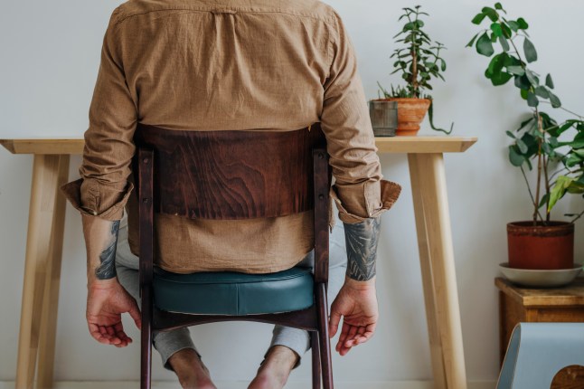 Anonymous Tattooed Man Sitting at His Home Office