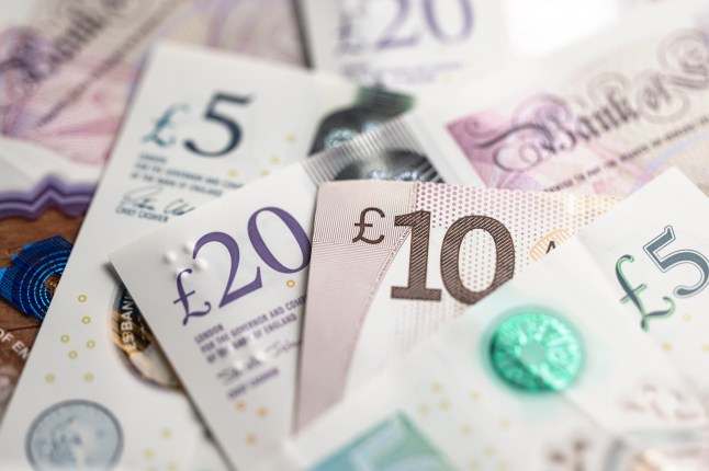 British Pound Sterling Banknotes and Coins. Close up of Bank of England notes.