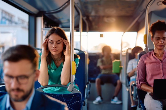 Exhausted nurse feeling headache after work, commuting by bus