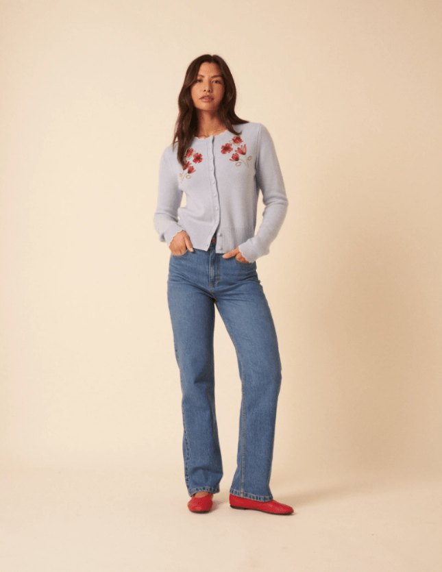 Female wears knitted cardigan with jeans and red shoes