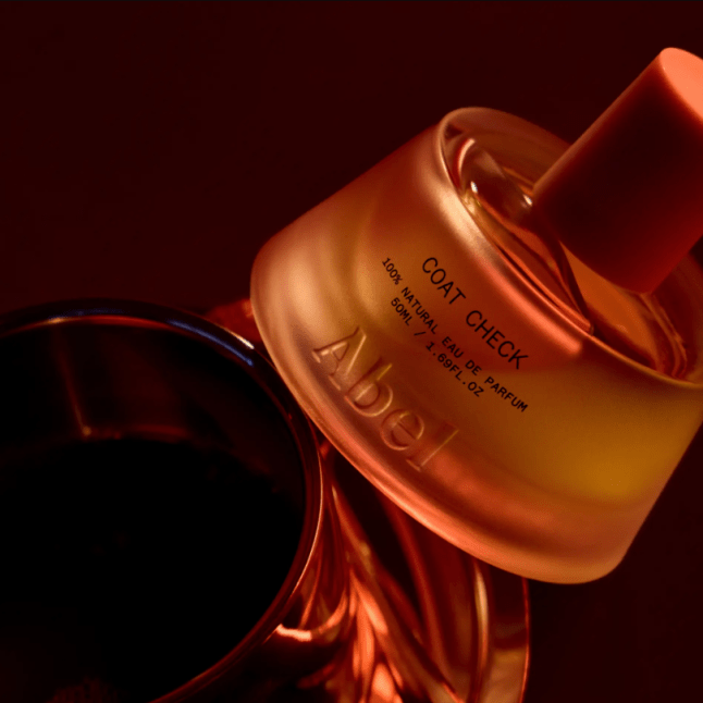 Bottle of fragrance on a dark background