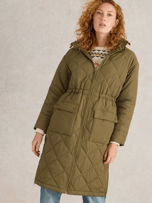 Female wears padded green White Stuff coat