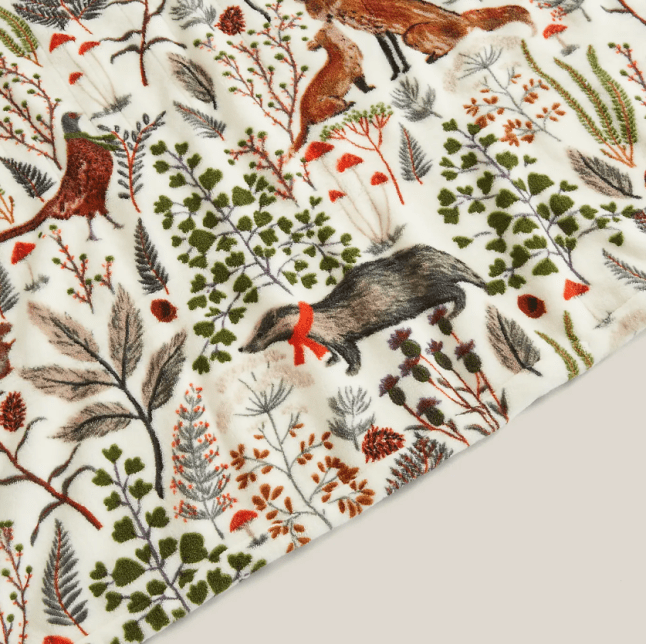 Printed fleece blanket from Dunelm with woodland creatures on