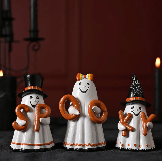 Three ghost figures, spelling out the word 'spooky'