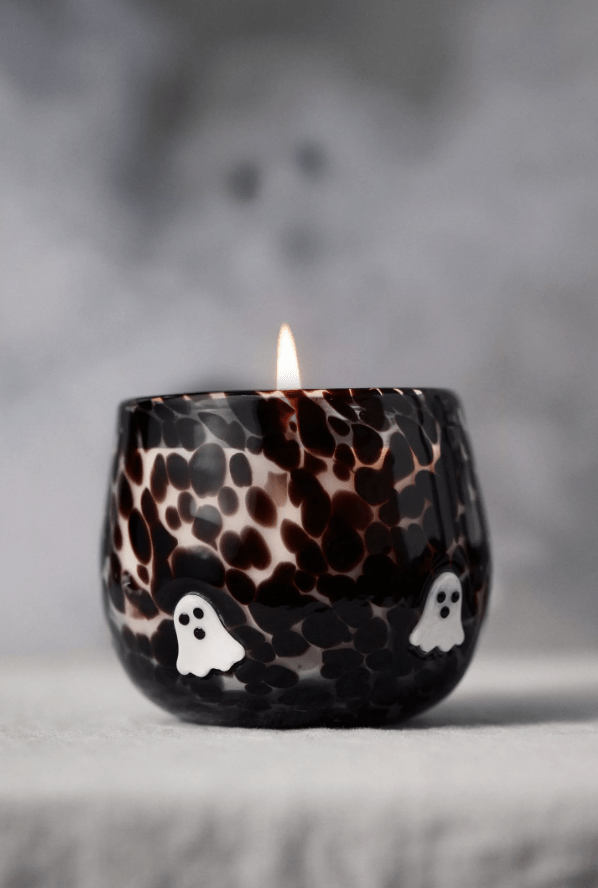 Black glass candle with white ghosts