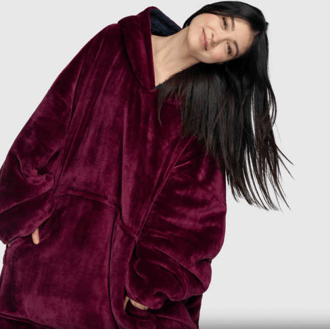 Female wears burgundy oversized hoodie