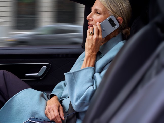 Female on the phone in the back of a car