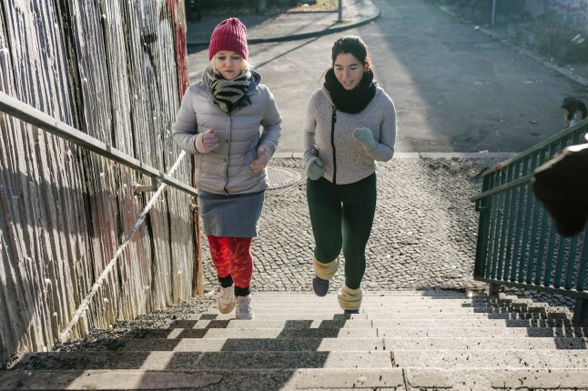 Women running stairs for fitness in the winter
