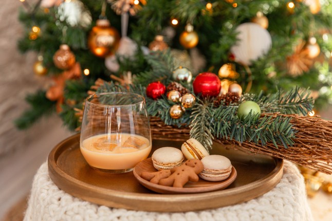 Cream liqueur on festive Christmas table with cookies and decorations
