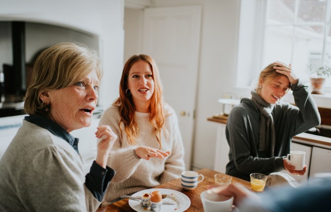 A family have a heated debate around a kitchen table