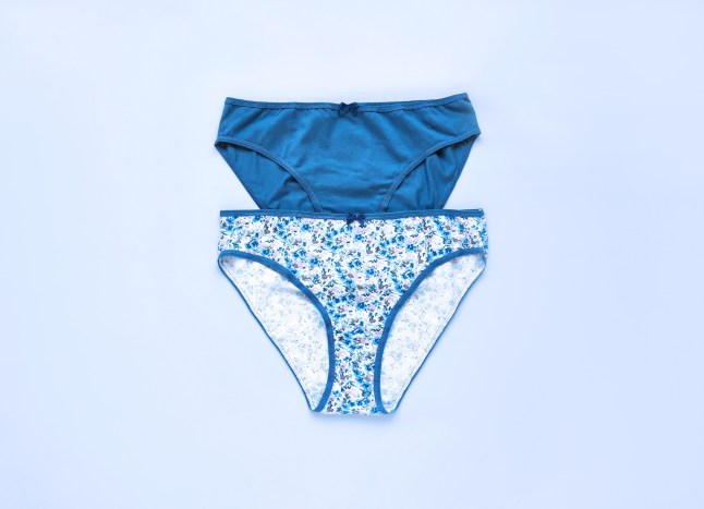 Classic women's underwear, cotton slip panties on blue background