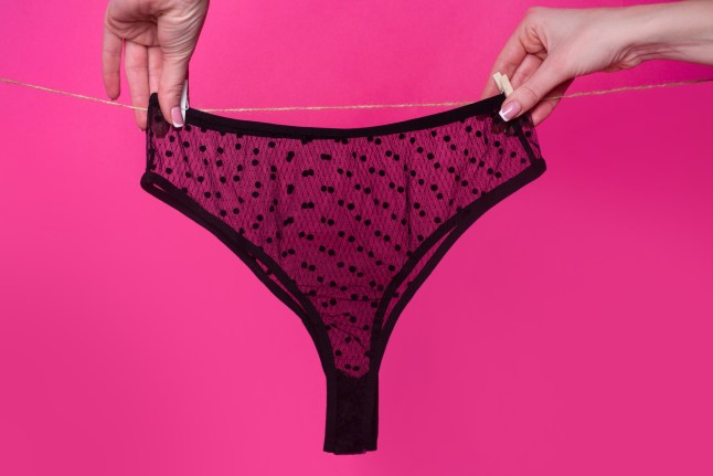 A woman hanging a thong on a washing line