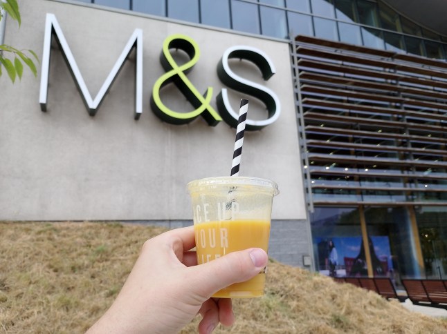 Smoothie in front of an M&S sign