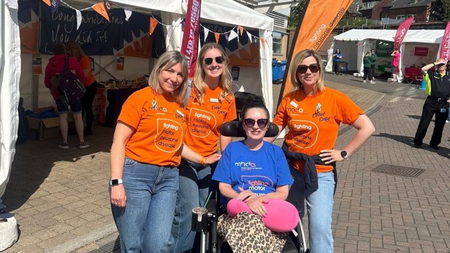Debbie Whitehouse and friends raising MND awareness with an orange flag and t-shirts