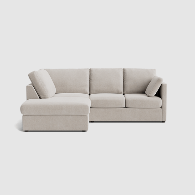 Beige coloured sofa with three cushions and enlongated edge