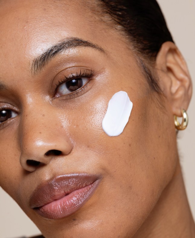 A face with a strip of Renew + Me cream on the cheek