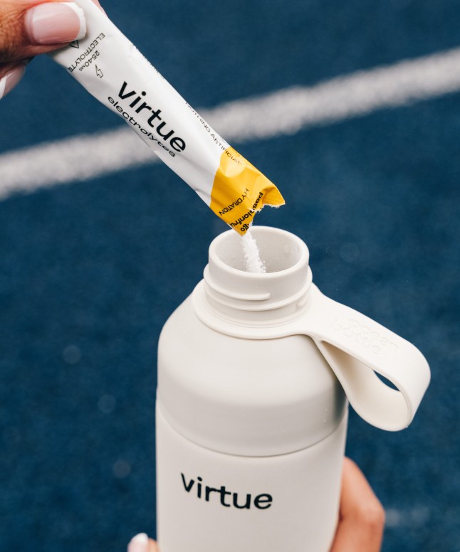Virtue electrolytes being poured into a water bottle